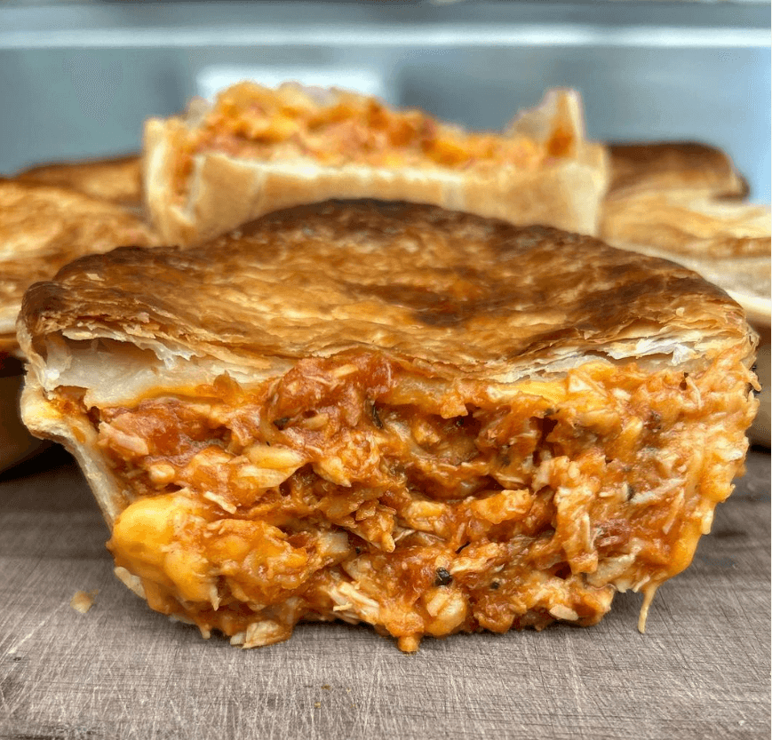 chicken pie cut in half revealing juicy contents